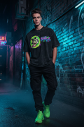 JuneBug men's oversized black tee with bold graffiti-style front chest logo on model wearing streetwear outfit