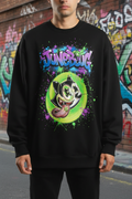 Junebugs oversized graphic tee with graffiti cat character and neon green paint splatter on white cotton unisex streetwear shirt