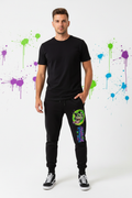 JuneBug men's black jogger pants with graffiti logo print running down the leg, shown on a male model in a streetwear outfit